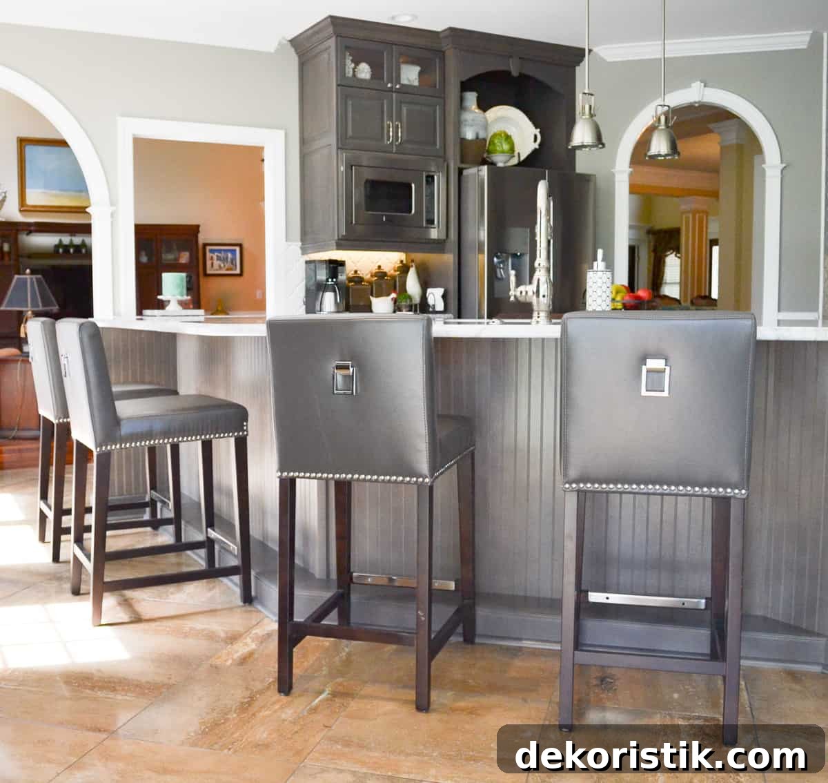 Stunning Kitchen Remodel: Before and After Reveal 11 front of gray kitchen island covered with beadboard paneling and gray leather barstools
