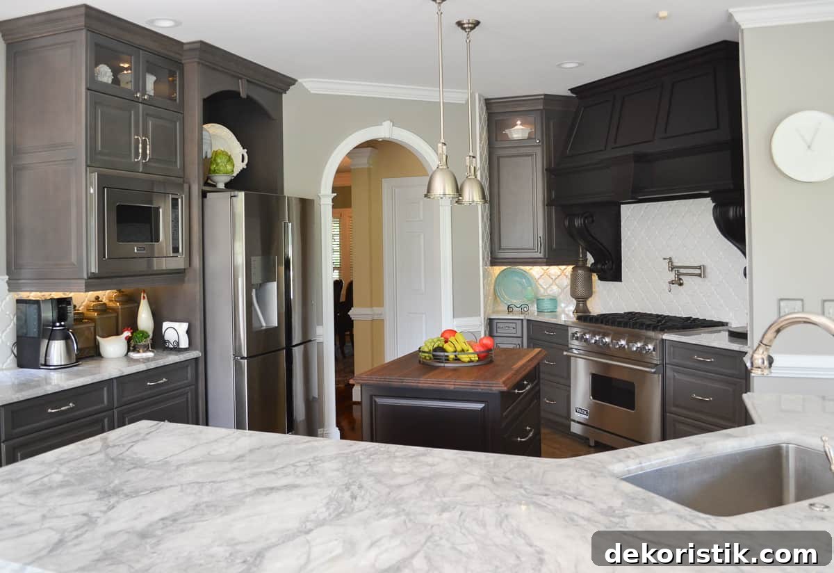 Stunning Kitchen Remodel: Before and After Reveal 7 view of a kitchen with gray custom cabinets and marble-look quartz counters