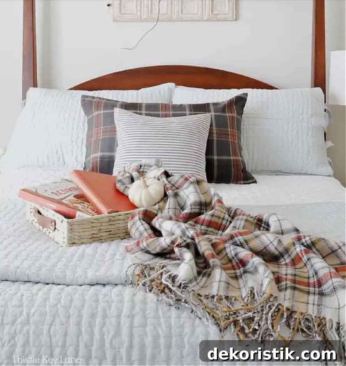Cozy Plaid Decor Ideas for Fall 10 Plaid fall decor with a plaid throw on a white bed with fall pillows